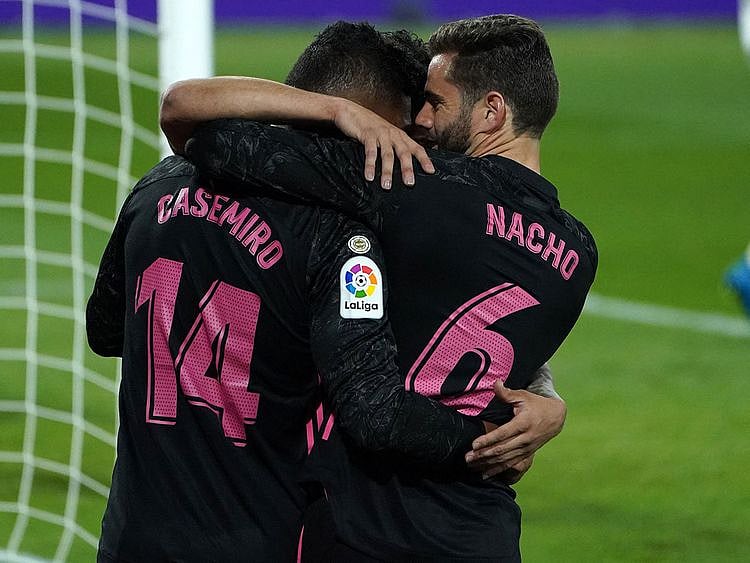 Real Madrid midfielder Casemiro celebrates with Nacho Fernandez after scoring against Real Valladolid 