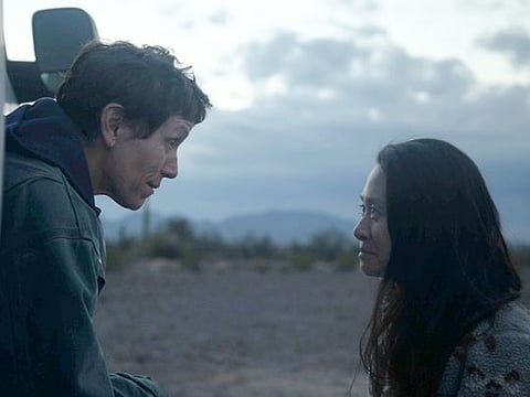 This image released by Searchlight Pictures shows Frances McDormand, left, and director Chloe Zhao on the set of "Nomadland."