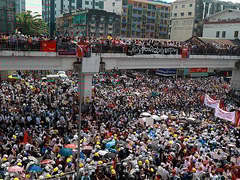 Anti-coup protesters gather at an intersection in downtown Yangon, Myanmar Monday, Feb. 22, 2021