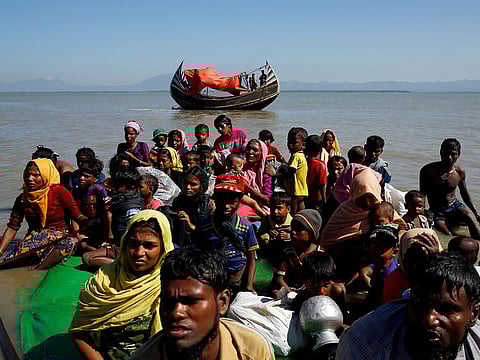 File photo: Rohingya refugees sit on a makeshift boat as they get interrogated by the Border Guard Bangladesh after crossing the Bangladesh-Myanmar border, at Shah Porir Dwip near Cox's Bazar, Bangladesh, on November 9, 2017. 