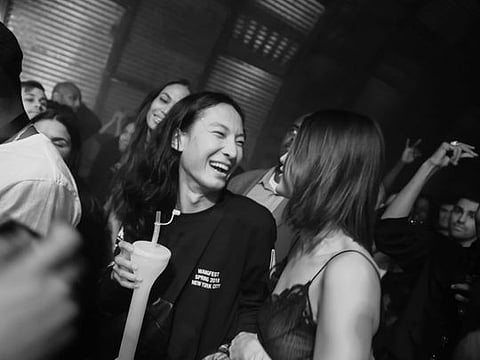 Alexander Wang and Bella Hadid at Wang’s post-fashion show party at a warehouse in New York, Sept. 10, 2017. The glamour of New York nightlife helped Wang build an empire. Now he is accused of sexual misconduct on the club scene.