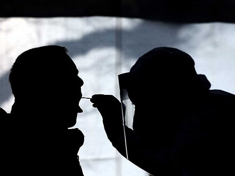 A health worker tests a person at a free of charge COVID-19 quick test centre on February 3, 2021, in Naumburg, eastern Germany. 
