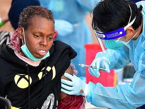 Registered Nurse Angelo Bautista administers the Moderna COVID-19 vaccine to eligible people identified by homeless service agencies from the parking lot of the L.A. Mission on February 24, 2021 in Los Angeles, California. 
