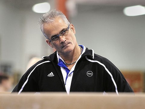 Gymnastics coach John Geddert watches his students during a practice in Lansing, Michigan, U.S. December 14, 2011.
