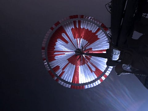 In an image from NASA/JPL-Caltech, the parachute that helped land the Perseverance spacecraft, seen from an upward-looking camera during landing on Mars on Feb. 18, 2021. Within hours of this images release on Monday, people figured out the message hidden in its pattern. 