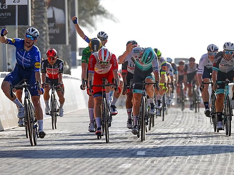 Sam Bennett (left) of  Deceuninck - Quick-Step exults after winning the sixth stage, the Dubai Stage, of UAE Tour on Friday.