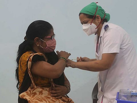 A health worker administers COVID-19 vaccine to a hospital staff in Mumbai, India, Monday, Feb. 22, 2021. 
