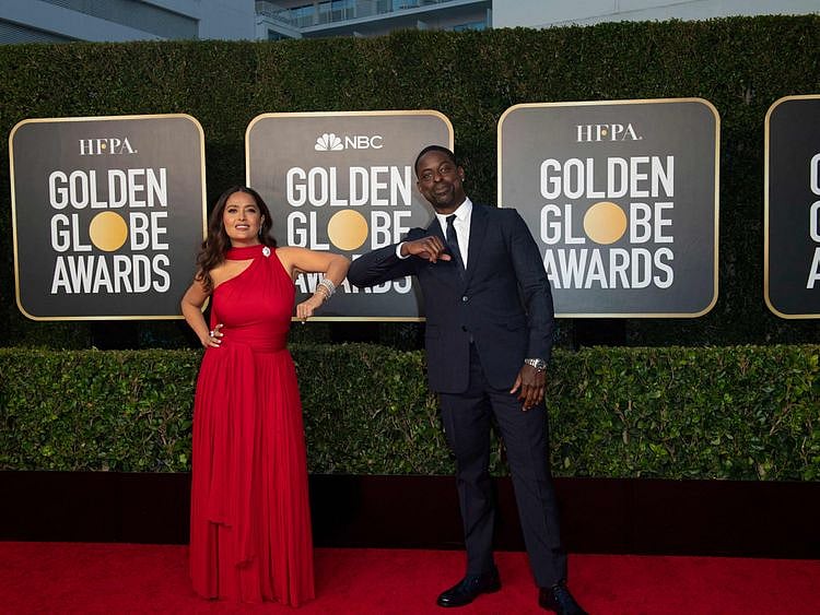 This handout photo courtesy of the HFPA shows Salma Hayek and Sterling K. Brown elbow bump at the Golden Globes