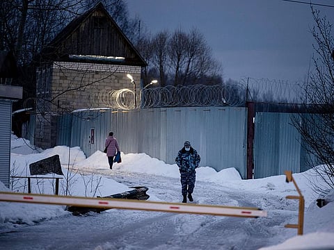 An officer of the Russian Federal Penitentiary Service walks near the gate of the penal colony N2, where Kremlin critic Alexei Navalny has been transferred to serve a two-and-a-half year prison term for violating parole, in the town of Pokrov on March 1, 2021. 