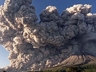 Photos: Indonesia's erupting Sinabung volcano belches column of ash  