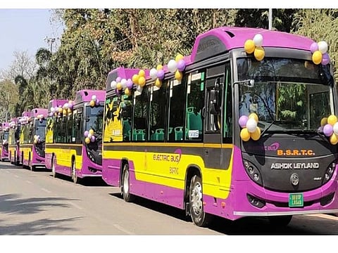 Electric buses lined up on a Patna road before their inauguration.