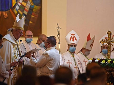 Pope Francis reads the liturgy as he leads mass at Baghdad's Saint Joseph Cathedral on the second day of the first papal visit to Iraq on March 6, 2021. - Pope Francis made a plea for peace today, telling those gathered at an interreligious service in southern Iraq that he hoped the world would "journey from conflict to unity." 