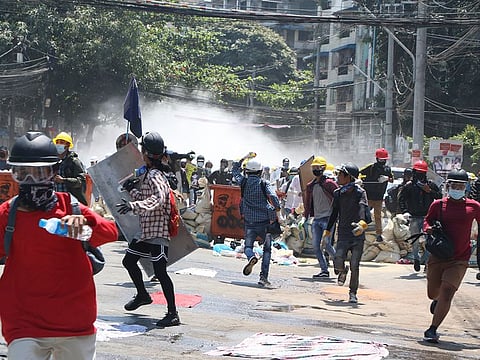 Protesters are dispersed as police fire tear gas during a demonstration in Yangon, on March 8, 2021.  