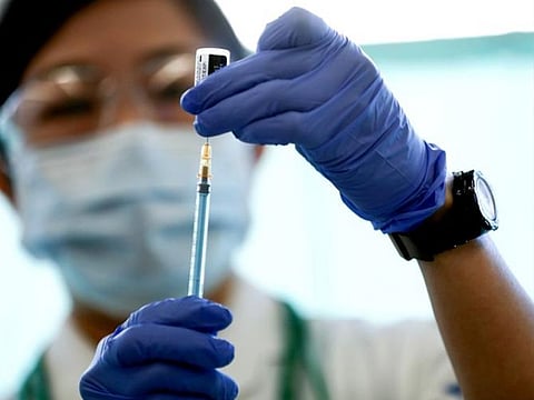 A medical worker fills a syringe with a dose of the Pfizer-BioNTech coronavirus disease (COVID-19) vaccine at Tokyo Medical Center in Tokyo, Japan.