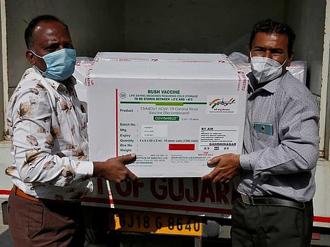 Officials unload boxes containing vials of AstraZeneca's COVISHIELD, a coronavirus disease (COVID-19) vaccine manufactured by Serum Institute of India, outside a vaccination storage centre in Ahmedabad, India, January 12, 2021. 