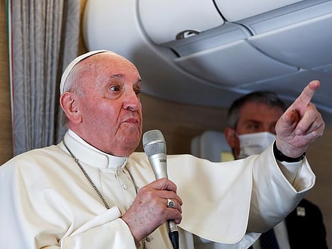 Pope Francis gives a news conference aboard the papal plane on his flight back after visiting Iraq, on March 8, 2021. 