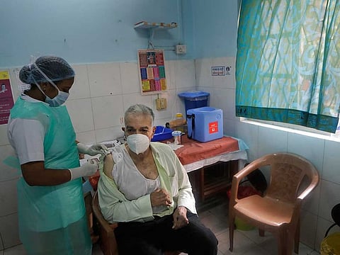 An elderly Indian man receives COVID-19 vaccine in Mumbai, India, Wednesday, March 10, 2021. 