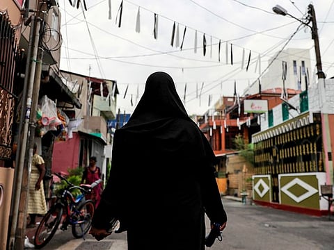 A Muslim woman wearing a hijab walks through a street near St Anthony's Shrine, in Colombo. 