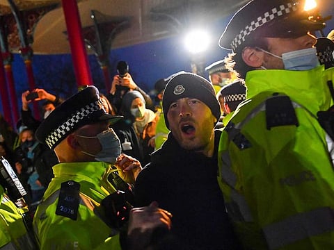 Mourners clash with police officers at a memorial site at the Clapham Common Bandstand, during a vigil following the kidnap and murder of Sarah Everard, in London, Britain.
