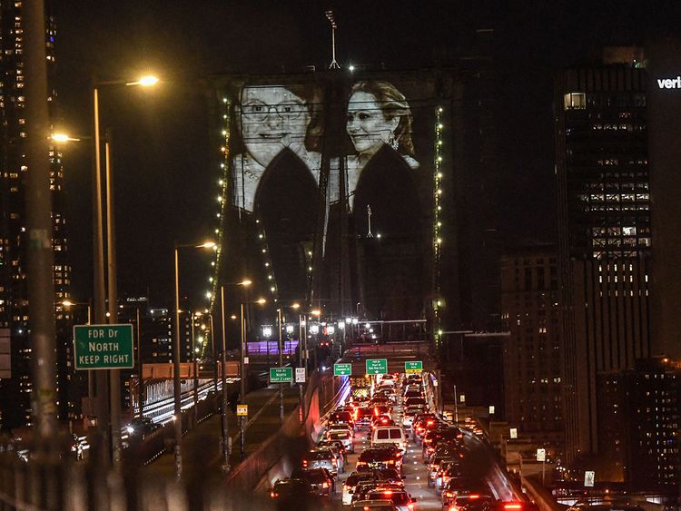 Images of New Yorkers lost to the COVID-19 pandemic are projected on to the Brooklyn Bridge on March 14, 2021 in New York City.