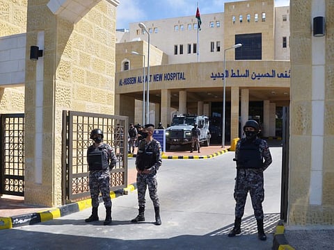 Gendarmerie officers stand guard at the gate of the new Salt government hospital in the city of Salt, Jordan.