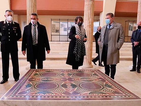 Authorities stand around a 1.5 square metre colorful mosaic dating back to AD 40 and belonging to the flooring of Caligula’s lavish ceremonial ships, that was found thanks to a joint police operation in the rooms of a Manhattan house and returned to the museum of Nemi, near Rome, Thursday, March 11, 2021. In September 2017, the department for cultural heritage protection of the Italian Carabinieri police, in collaboration with New York district attorney, managed to sequester the mosaic from the house of an Italian-American woman who brought it in the states illegally many decades earlier. 