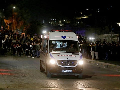 An ambulance leaves the site of a protest by mainly young Jordanians demonstrators against measures imposed by authorities to curb the spread of COVID-19, in Amman on March 15, 2021.
