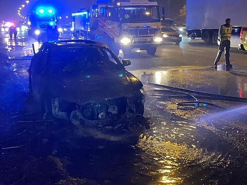 The fire extended to trees on the side of the road
