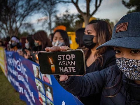  Julie Tran holds her phone during a candlelight vigil in Garden Grove, California, on March 17, 2021 to unite against the recent spate of violence targetting Asians and to express grief and outrage after yesterday's shooting that left eight people dead in Atlanta, Georgia, including at least six Asian women. 