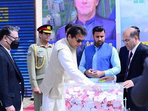Prime Minister Imran Khan inaugurates the balloting ceremony of low-cost housing project for low-wage workers in Islamabad on March 18, 2021.