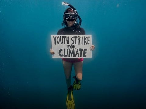 Mauritian scientist and climate change activist Shaama Sandooyea 24, holds a placard reading Youth Strike For Climate, during an underwater protest at the Saya de Malha Bank to highlight the need to protect the world's largest seagrass meadow within the Mascarene plateau, Mauritius.