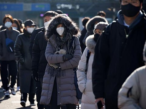 People wait in a line to undergo coronavirus disease (COVID-19) test at a coronavirus testing site in Seoul, South Korea.