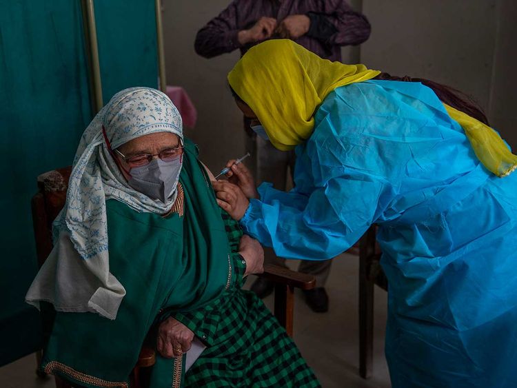An elderly Kashmiri Ameena Begum receives the Covishield vaccine for COVID-19 at a primary health center in Srinagar, Friday, March 19, 2021. 