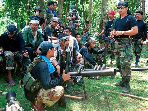 In this undated file photo, Abu Sayyaf spokesman Abu Sabaya, right foreground, is seen with his band of armed extremists. Philippine troops killed an Abu Sayyaf rebel commander blamed for years of ransom kidnappings and rescued the last of his four Indonesian captives, the military said.
