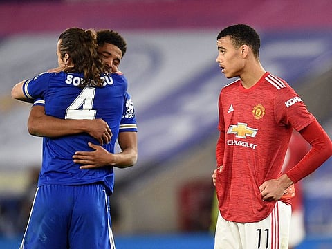 Manchester United's Mason Greenwood looks on as Leicester City's Caglar Soyuncu and Wesley Fofana celebrate after the match.