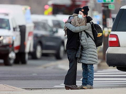 Women hug on the corner of Broadway and Table Mesa Drive near a King Soopers grocery store where a shooting took place, Monday, March 22, 2021, in Boulder, Colorado.