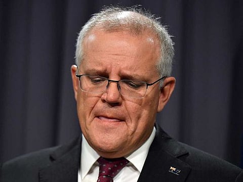 Australian Prime Minister Scott Morrison reacts while speaking during a press conference at Parliament House in Canberra, Tuesday, March 23, 2021. Morrison said he was shocked and disgusted by the latest sex scandal to rock his government and vowed to do more to attract women into politics.