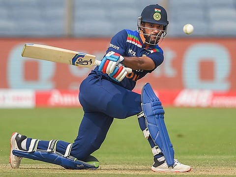 Shikhar Dhawan launches into a sweep during an attacking innings of 98 in Pune on Tuesday. 