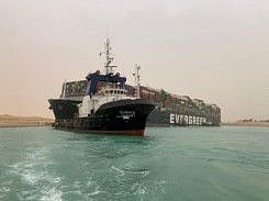 A container ship which was hit by strong wind and ran aground is pictured in Suez Canal, Egypt March 24, 2021.