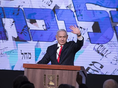 Benjamin Netanyahu, Israel's prime minister and the leader of the Likud party, waves to his supporters on stage during a party event in Jerusalem, Israel, on Wednesday, March 24, 2021. 