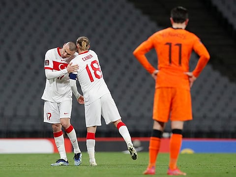 Turkey's Burak Yilmaz, left, celebrates after scoring his side's fourth goal.