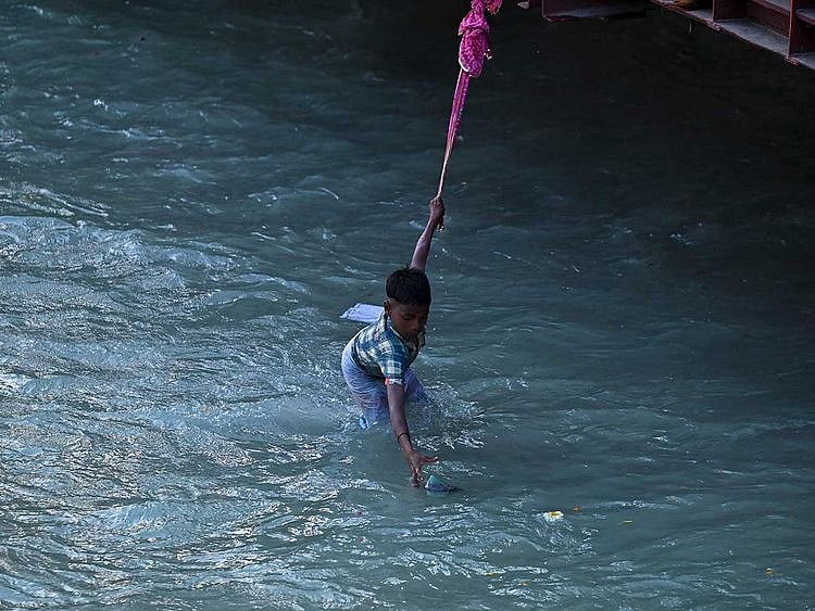 Boy Ganga coins Ganges Hindu river