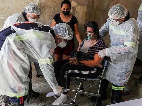 Emergency Mobile Care Service (SAMU) workers transport Marley das Gracas, 42, who tested positive for the coronavirus disease (COVID-19), to an emergency care unit, at her house in Sao Bernardo do Campo, Brazil, March 24, 2021. 