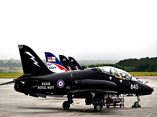 A Royal Navy Hawk T1 jet has crashed during a training exercise in Wales. Two pilots ejected moments before the aircraft crashed in flames.