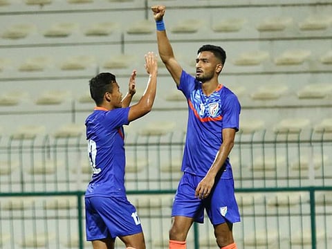India's Manjit Singh (right) celebrates with a teammate after scoring their equaliser during their friendly in Dubai. 
