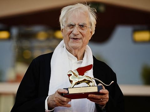 In this Sept. 8, 2015, file photo, director Bertrand Tavernier poses with his Golden Lion for Lifetime Achievements after the award ceremony at the 72nd edition of the Venice Film Festival in Venice, Italy.
