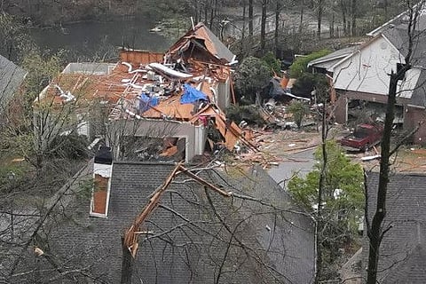 A house is left missing a roof after a tornado passed through the Eagle Point subdivision in Hoover, Alabama, U.S. 