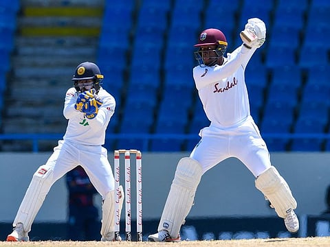 Nkrumah Bonner of the West Indies picks up a boundary during his century on the final day of the first Test at Antigua and Barbuda on Thursday.