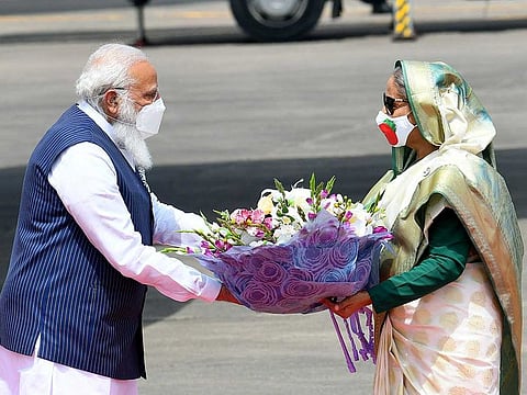 Prime Minister Narendra Modi being felicitated by Bangladesh Prime Minister Sheikh Hasina as he arrives for a two-day visit to Bangladesh, in Dhaka on Friday, March 26, 2021. 