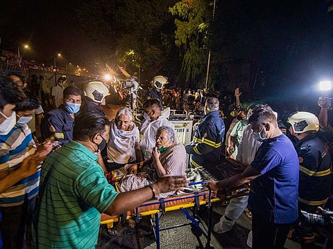 Patients from the COVID-19 dedicated Sunrise Hospital being shifted after a fire in the adjacent Dreams Mall, in Mumbai, early Friday, March 26, 2021. 